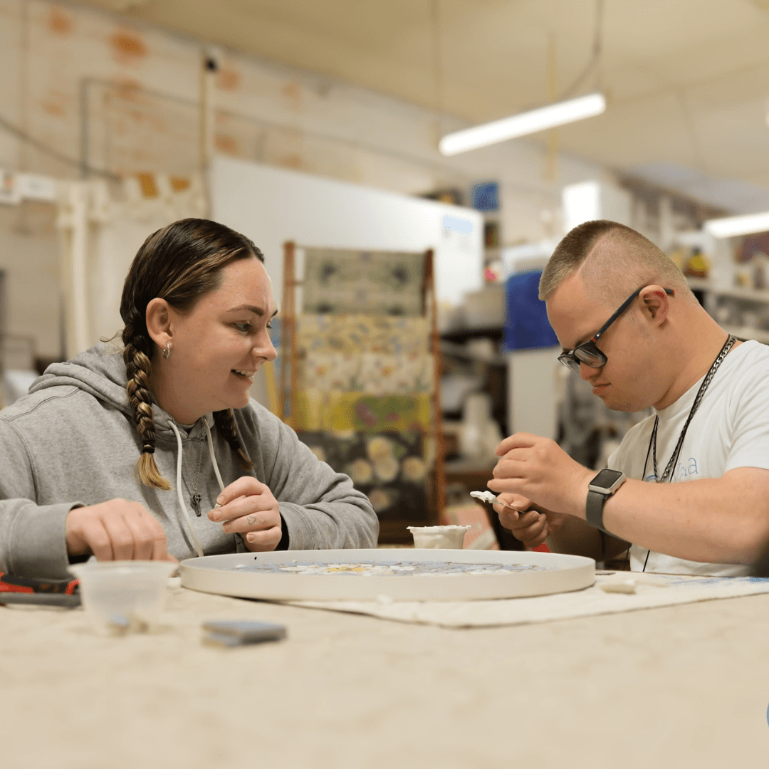 A Vana Care participant and support worker making art together