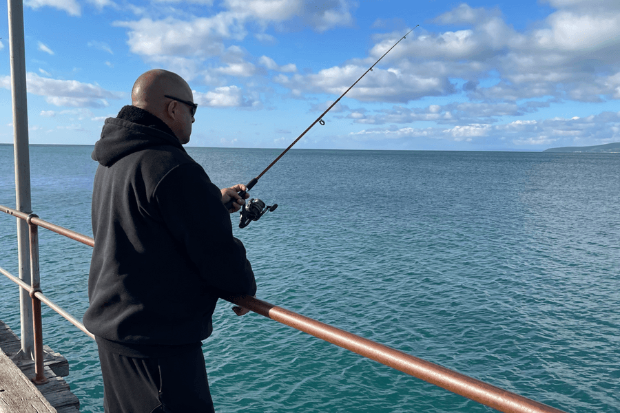 Vana Care participant Luke fishing with his support worker